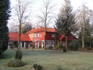 a large red house with a red roof at Gästehaus Heidehof in Soltau