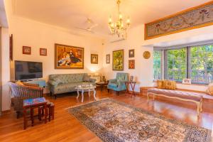 a living room with a couch and a table at Seclude Hampi 1800 in Sandūr
