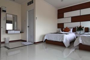 Postel nebo postele na pokoji v ubytování TTT Hotel