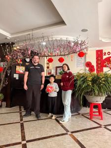 a man and a woman and a child standing in a store at Sapphire Sapa Hotel in Sapa