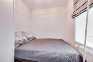 a small bedroom with a bed and a window at Central Platinum Apartments 23 in Rybnik