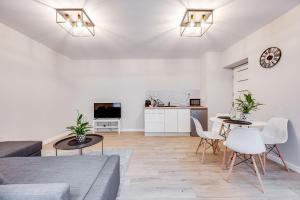 a living room with a couch and a table at Central Platinum Apartments 23 in Rybnik