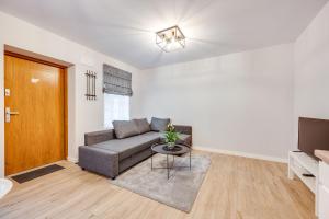 a living room with a couch and a table at Central Platinum Apartments 23 in Rybnik