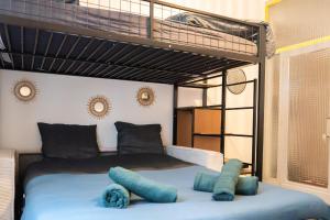 a bedroom with a bunk bed with blue pillows at Charming studio with sofa, bed and terrace-AS in Carcassonne