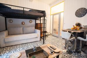 a living room with a bunk bed and a table at Charming studio with sofa, bed and terrace-AS in Carcassonne