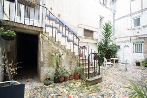 an entrance to a building with a staircase and plants at Charming studio with sofa, bed and terrace-AS in Carcassonne