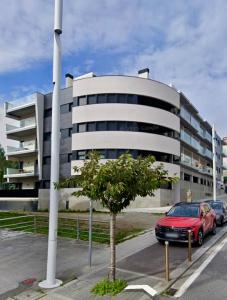 a red car parked in front of a building at Brisa Marela in Sanxenxo