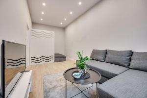 a living room with a couch and a table at Central Platinum Apartments 26 in Rybnik