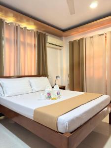 a bedroom with a large bed in a room at Buena's Haven Travelodge in El Nido