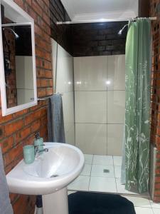 a bathroom with a sink and a shower at Kubbe Comfort Corner in Bloemfontein +34 photos