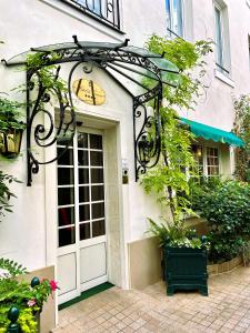 an entrance to a building with a white door at Hôtel de Varenne in Paris