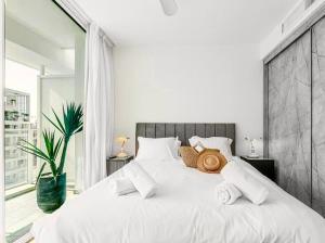 a white bed in a bedroom with a large window at Redsearent suite with pool view 2 in Eilat +9 photos