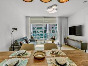 a living room with a table and a living room with a couch at Redsearent suite with pool view 2 in Eilat
