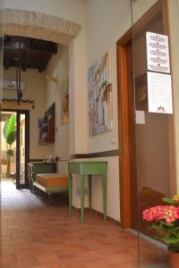 a room with a green table and a bench at Palazzo Dei Corsari in Trapani