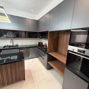 a kitchen with gray cabinets and a sink at Serenity Sea Villa Taghazout Bay Amda in Taghazout