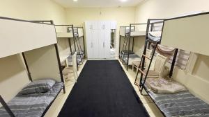 a room with several bunk beds in a room at Hostella in Salor Bekati