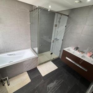 a bathroom with a shower and a tub and a sink at Serenity Sea Villa Taghazout Bay Amda in Taghazout +33 photos