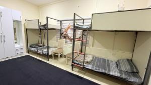 a room with three bunk beds in it at Hostella in Salor Bekati