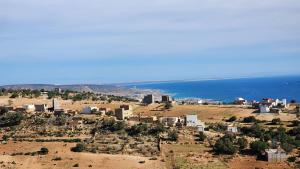 an aerial view of a city and the ocean at La Cabane Surf Lodge in Agadir