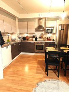a kitchen with a table and a dining room at Luhtitalo two-room apartment in Rovaniemi