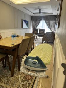 a dining room with a table and a vacuum at Puchong Permata Homestay 3BR in Puchong