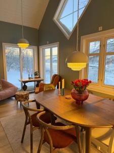 a living room with a wooden table and chairs at Cabin in Tappeluft in Alta +36 photos