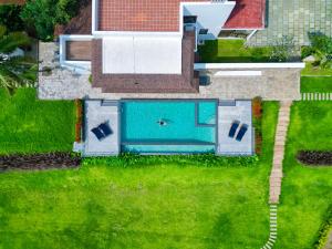 an overhead view of a swimming pool in a yard at Pollachi Riverhouse, A CGH Earth Saha experience in Pollāchi