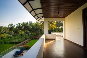 a view from the living room of a house at Pollachi Riverhouse, A CGH Earth Saha experience in Pollāchi