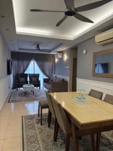 a living room with a table and a couch at Puchong Permata Homestay 3BR in Puchong
