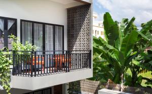 a balcony with a table and chairs on it at SK Residence in Siem Reap