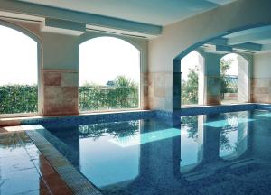 an indoor swimming pool with water in a house at Hotel Azimut in Sveti Stefan