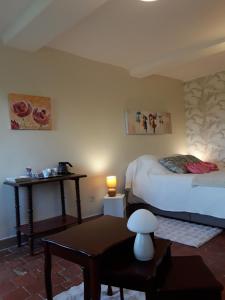 a room with two beds and a table with a lamp at La Guerandelle in Ernes