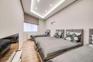 a bedroom with two beds and a mirror at Central Platinum Apartments 29 in Rybnik