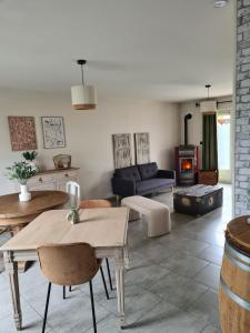 a living room with a table and a fireplace at Les malices d'Ulysse in Péronne