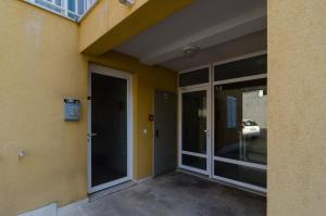 an entrance to a building with sliding glass doors at Apartment Cavtat Beauty in Cavtat