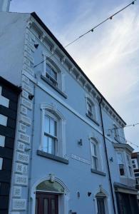 a white building with signs on the side of it at Rosa's Loft in Flamborough