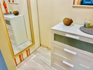 a bathroom with a dresser and a mirror at La Maison Nikaïa in Narbonne