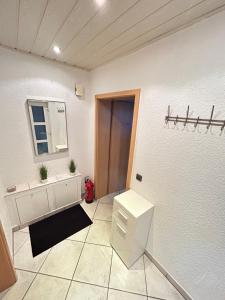 a bathroom with a sink and a mirror at Wohnung Ahorn in Riedstadt