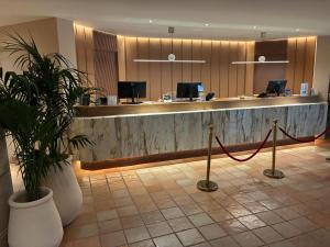 a lobby with a reception desk with a potted plant at Hotel Della Valle in Agrigento +45 photos