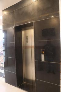 a elevator in a building with a man standing in it at Hotel Lakhdatar in Kota