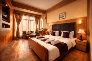 a bedroom with a large bed in a room at Hotel New Mamta in Srinagar