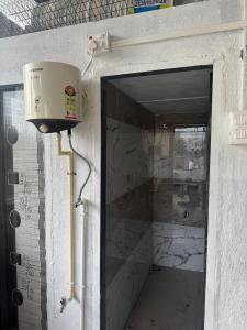 a door to a tunnel in a building with a box at Sumai Bhakt Niwas in Tuljapur