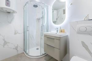 a white bathroom with a shower and a sink at Angie in Baška +26 photos