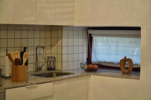 a kitchen counter with a sink and a window at A Bolota, Casa rural in Trevejo +4 photos