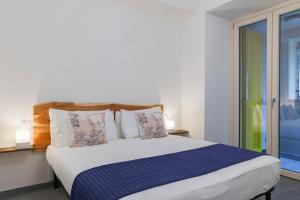 a bedroom with a large bed with a window at Villa Eugenia - Suite Iris in Carate Urio