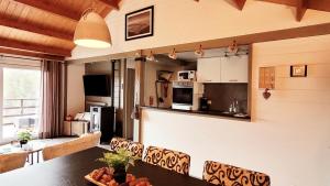 a kitchen and dining room with a table and chairs at chalet 275 in Rendeux