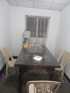 a dining room table with chairs and a telephone at Volunteer lanka in Padukka