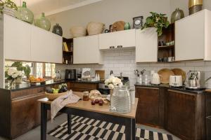 a kitchen with a table with fruit on it at Am Flus- at the river in Stellenbosch +35 photos