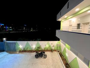 a motorcycle parked on a balcony at night at Hotel ZB comforts MYSORE in Mysore