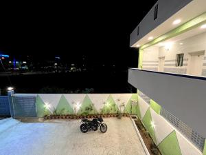 a motorcycle parked on a balcony at night at Hotel ZB comforts MYSORE in Mysore
